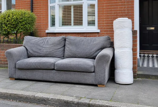 Sofa and rolled mattress left outside ready for collection